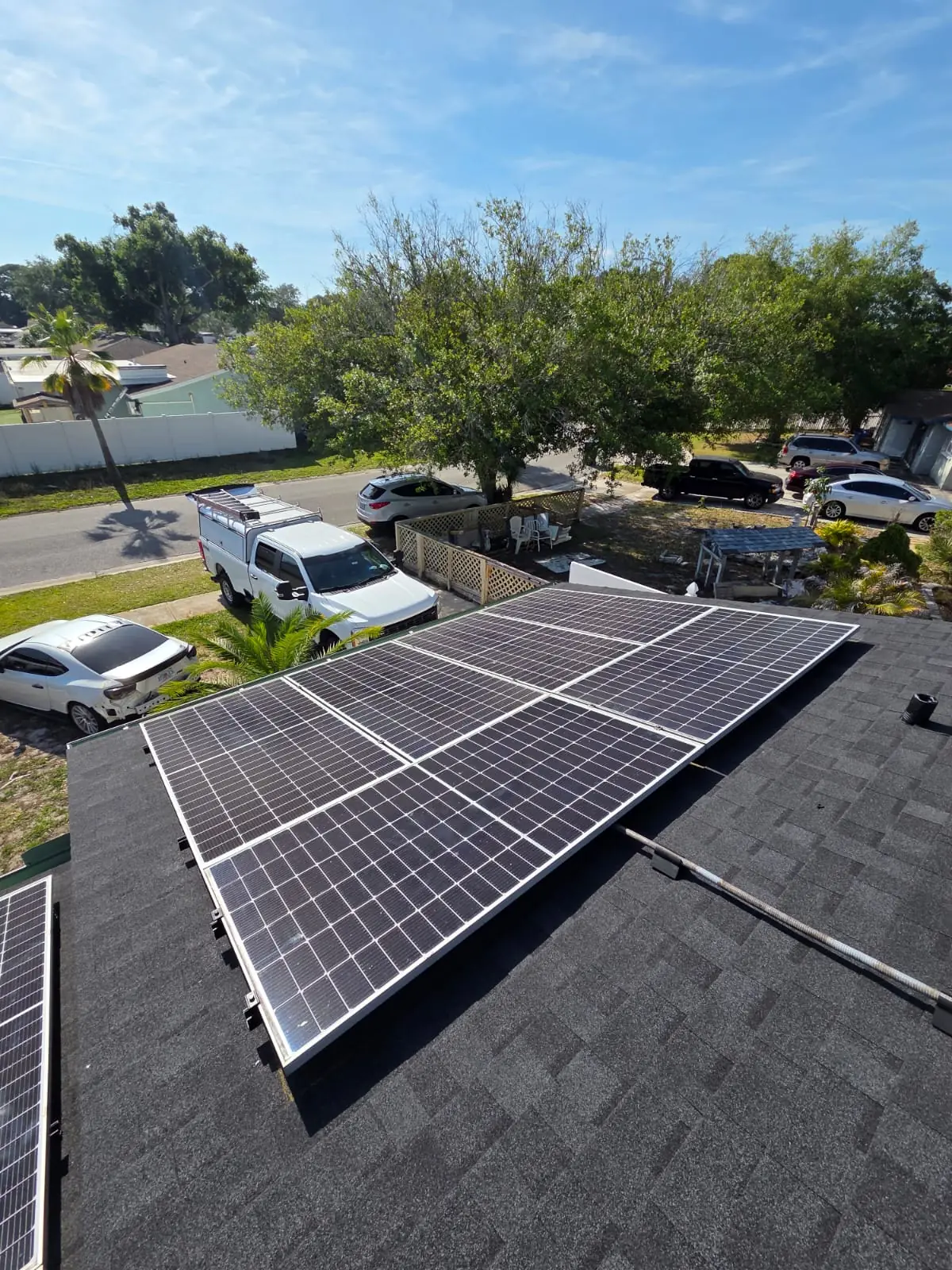 Solar panels on a Florida shingle roof before removal
