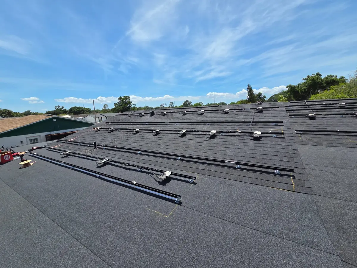 Solar panels lifted off the roof, exposing the shingles underneath